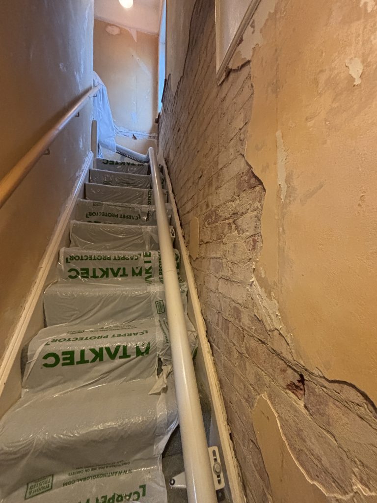 Wallpaper installation on staircase in Southampton during preparation and fitting stage