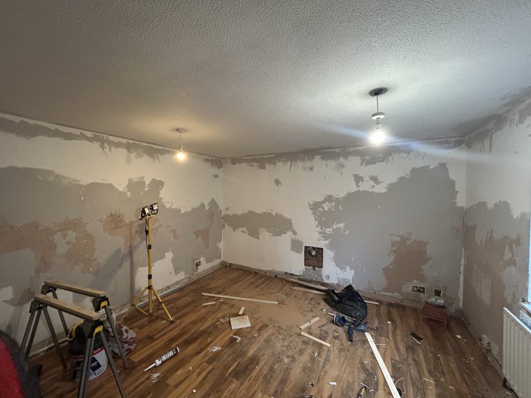 Living room in Southampton during renovation showing wall preparation and old plaster removal before plastering.