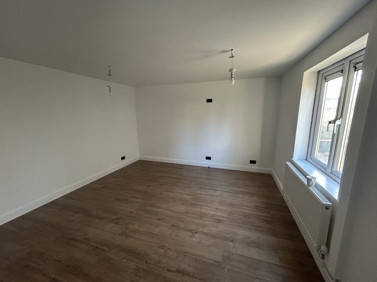 Freshly painted living room in Southampton after renovation with smooth white walls and new flooring.