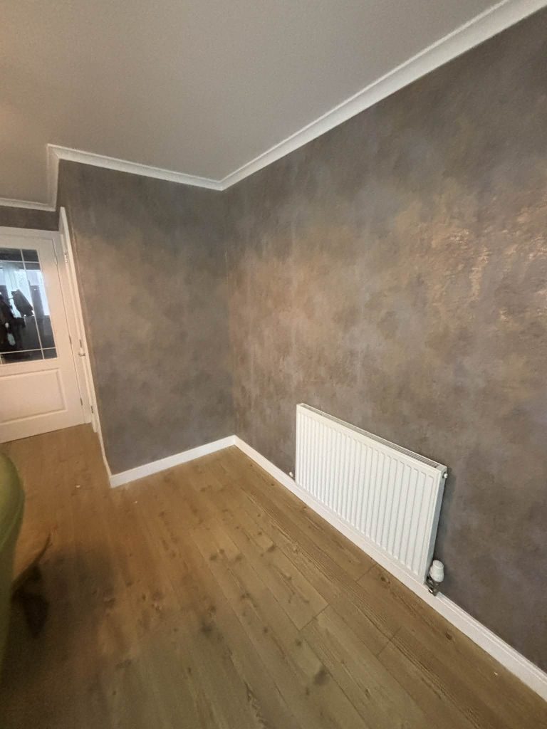 Decorative textured wallpaper applied with clean lines and seamless joins