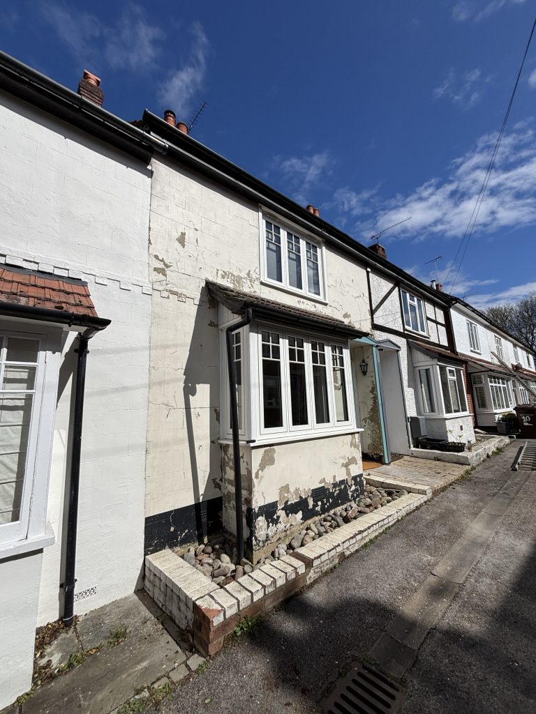 Damaged exterior walls before repair and painting in Southampton property