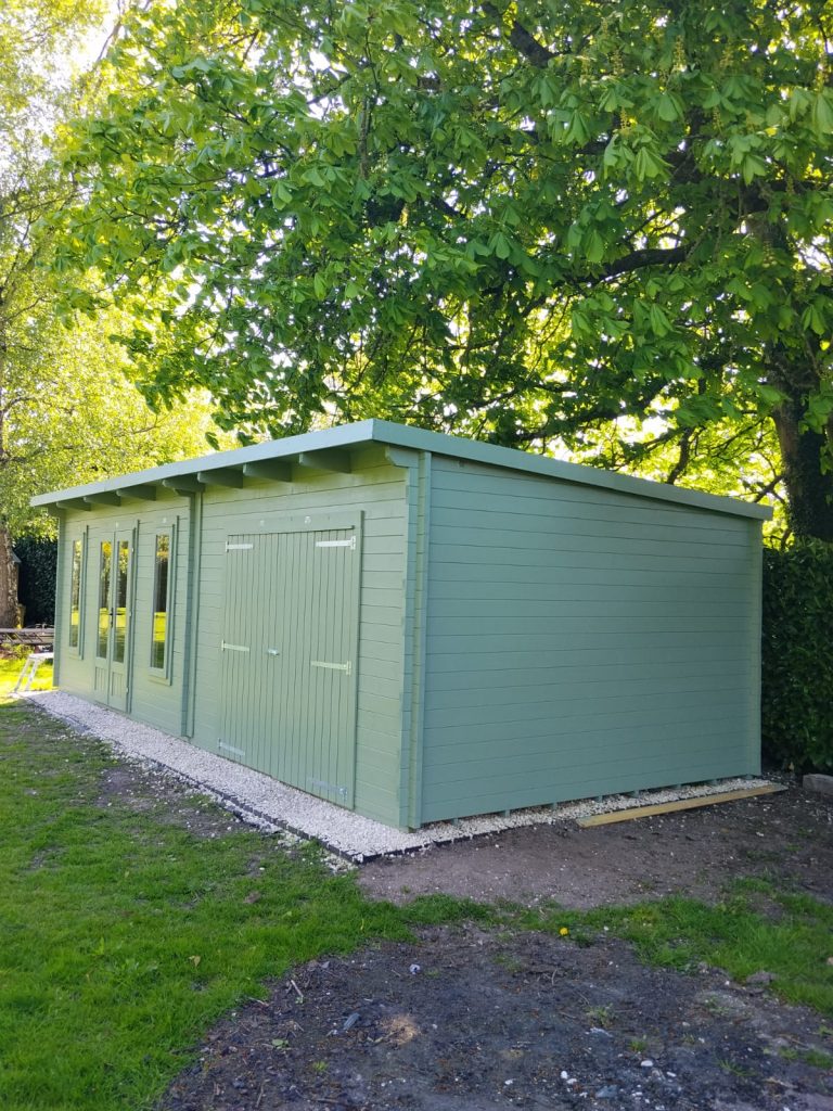 Completed summer house exterior painting with sage green finish in Southampton