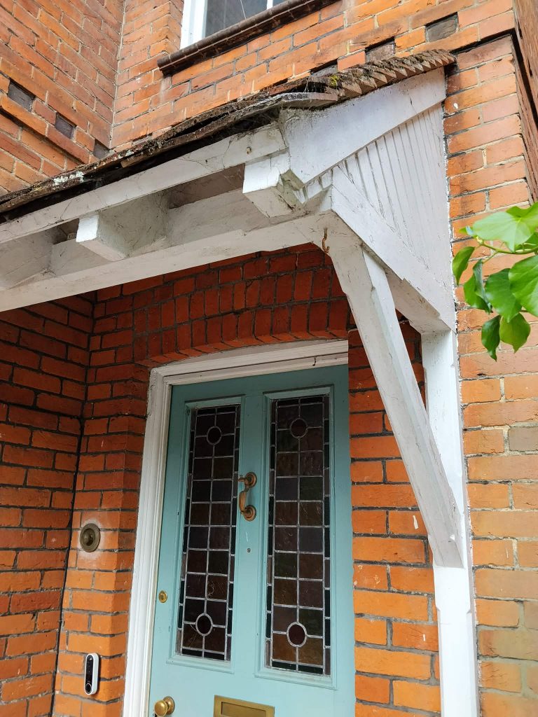 Porch timber woodwork before repairs and exterior painting in Southampton.