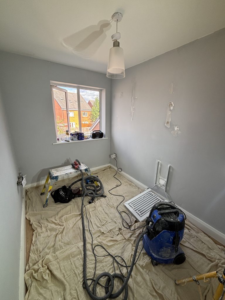 Peeling paint and damaged walls before repair in Southampton home office