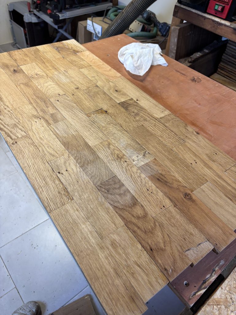 Reclaimed oak pieces being arranged for a handmade coffee table